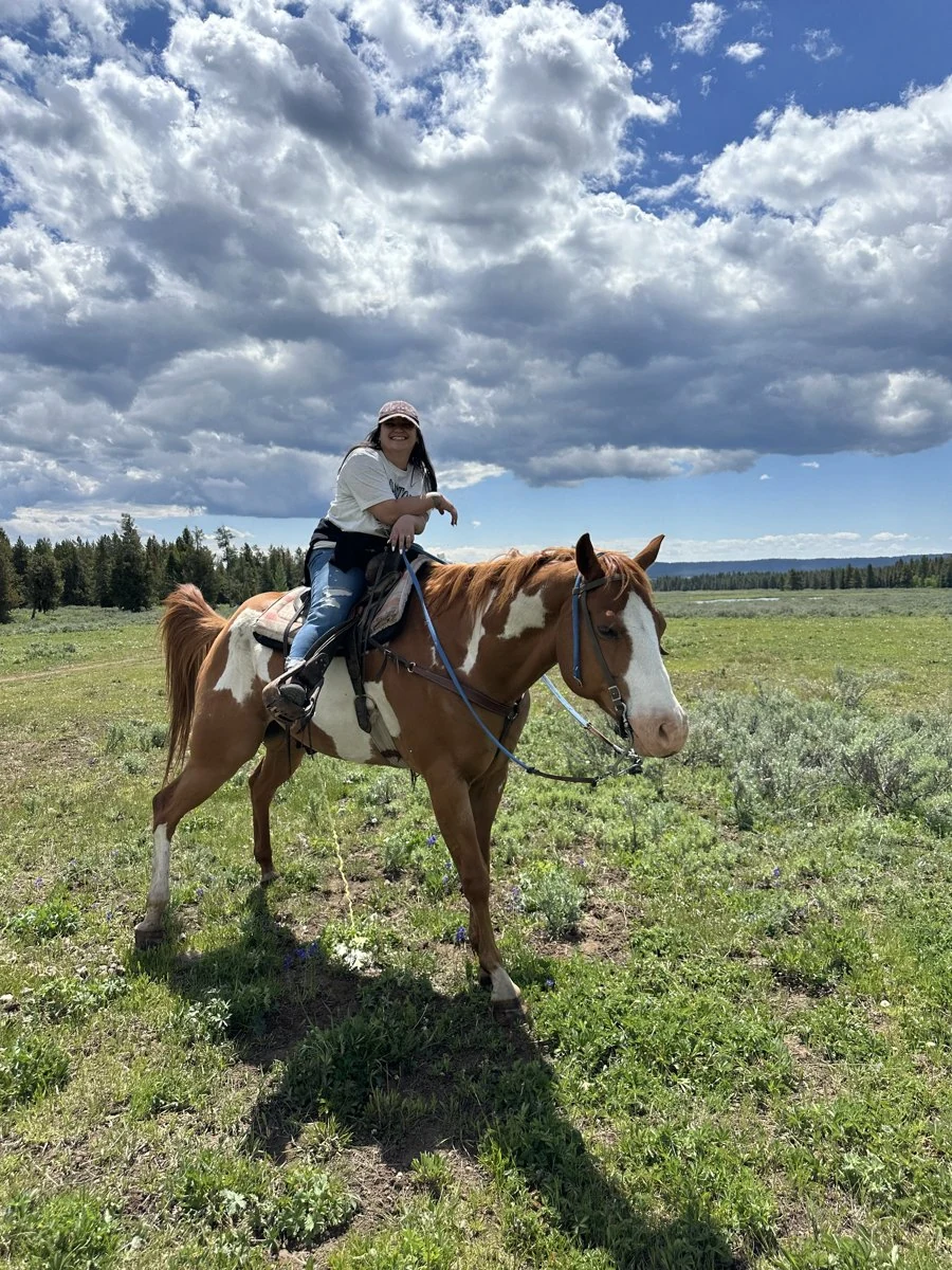 Horseback riding on a grassy trail
